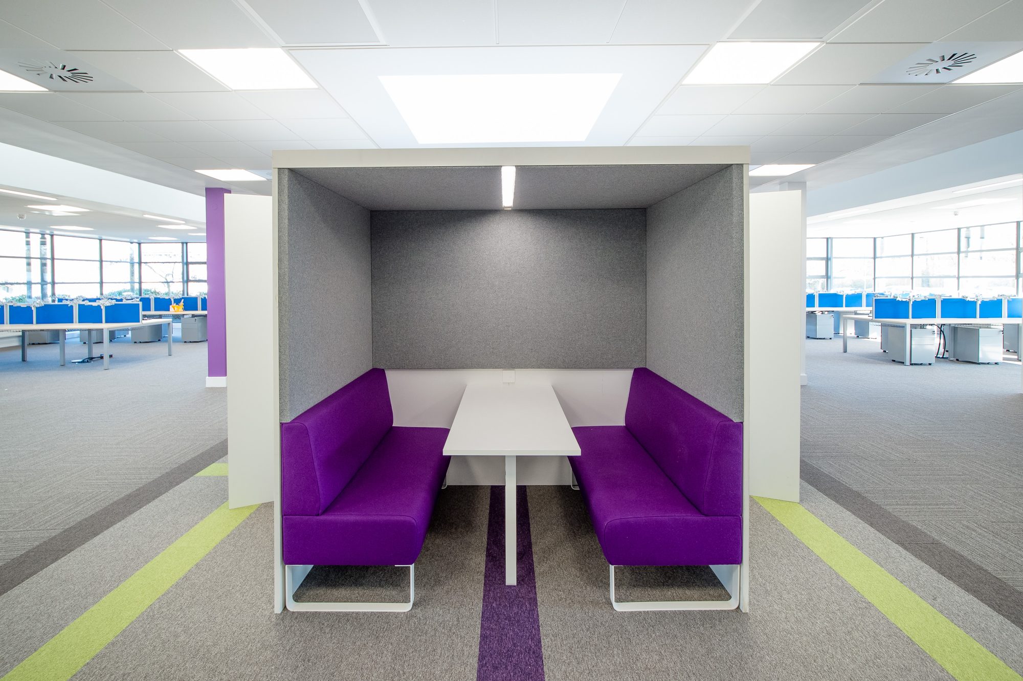 Purple-banquette acoustic booth with white table