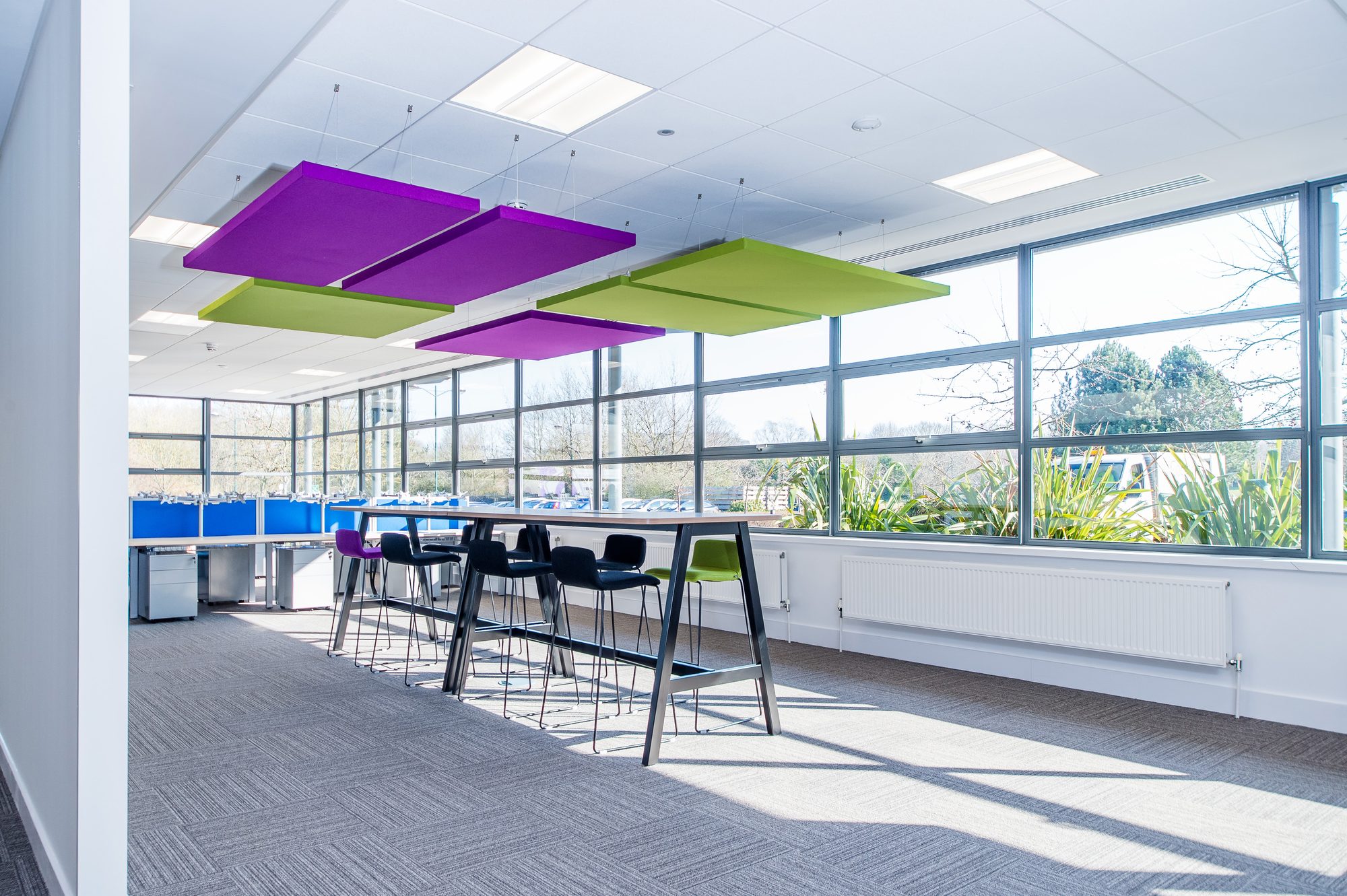 Walk-up collaboration pod with green and purple seating