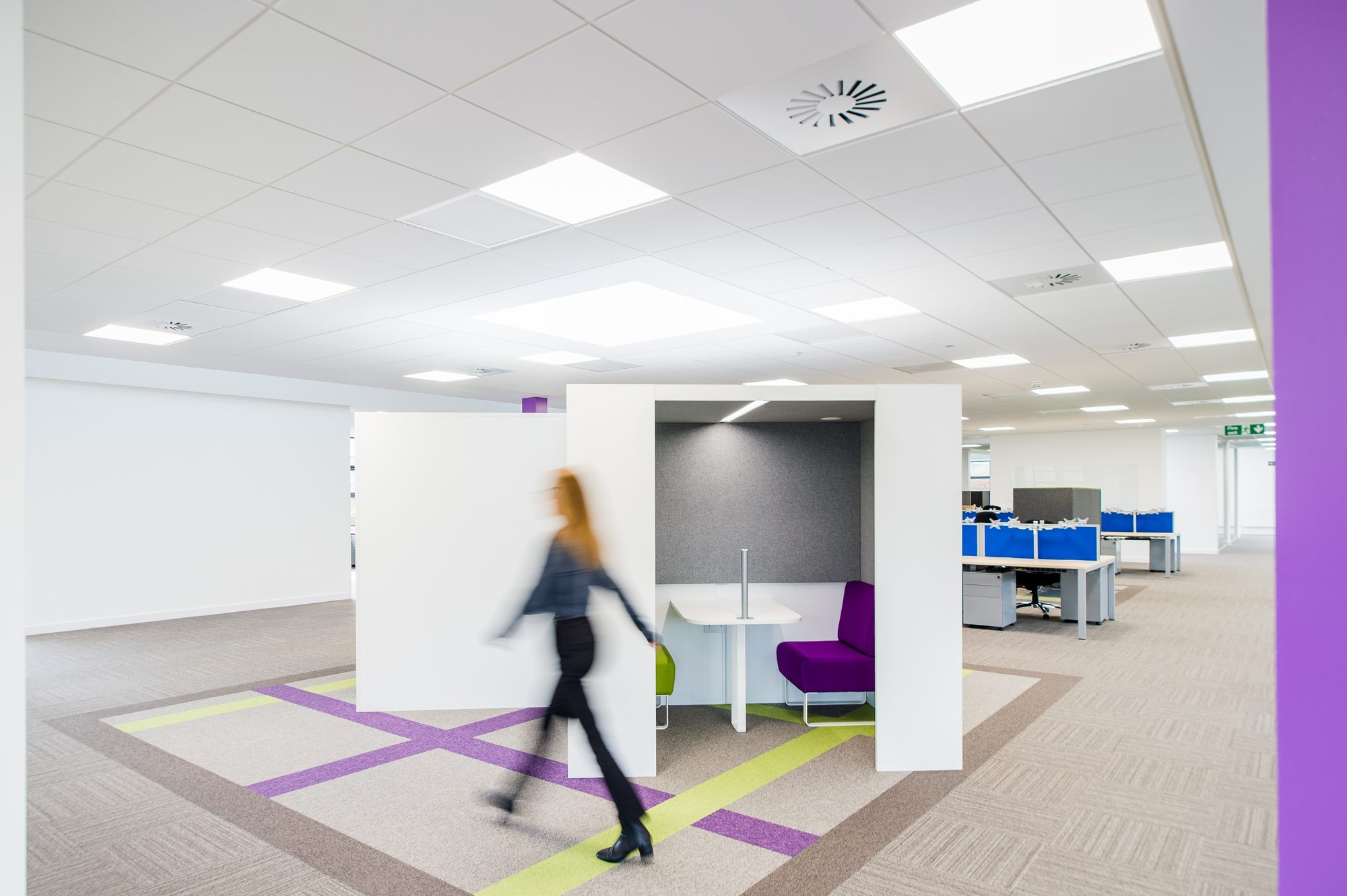 Collaboration pod with someone walking past, motion blur