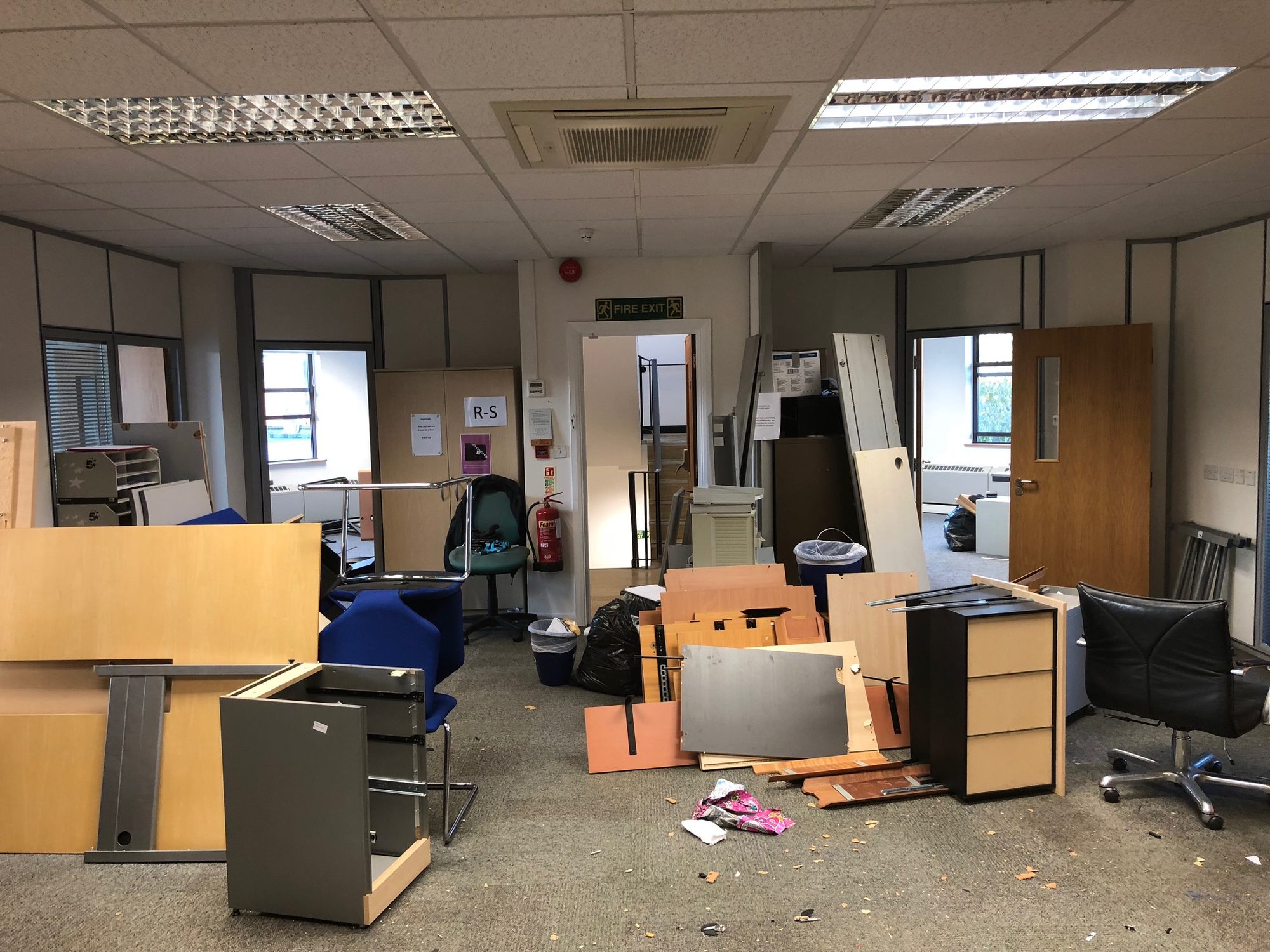 Mid strip-out with old desks, panels and chairs cleared from the floor
