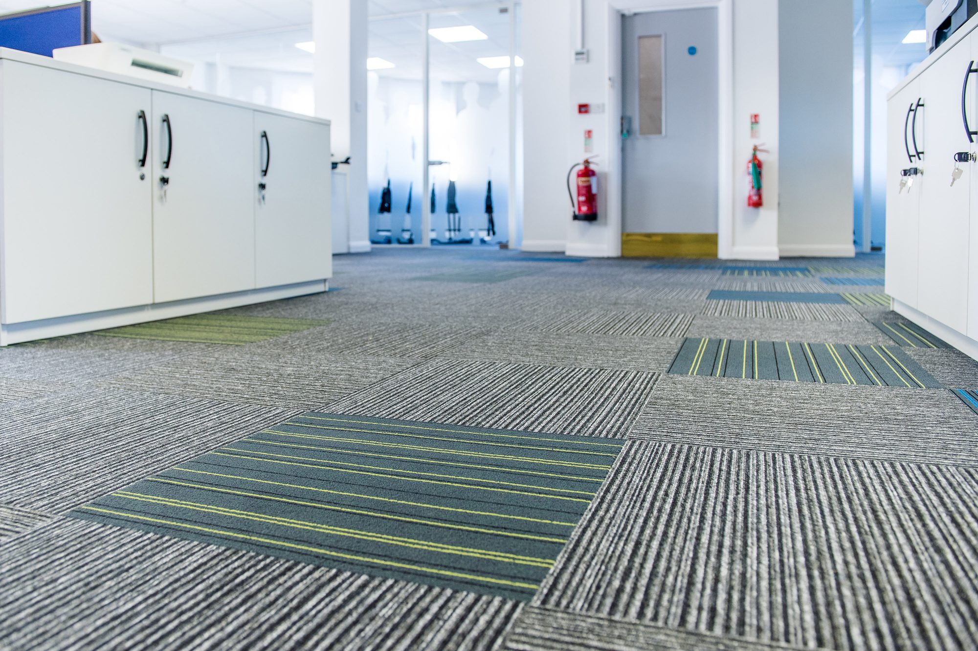 New patterned carpet tile floor with grey, blue and yellow accent strips