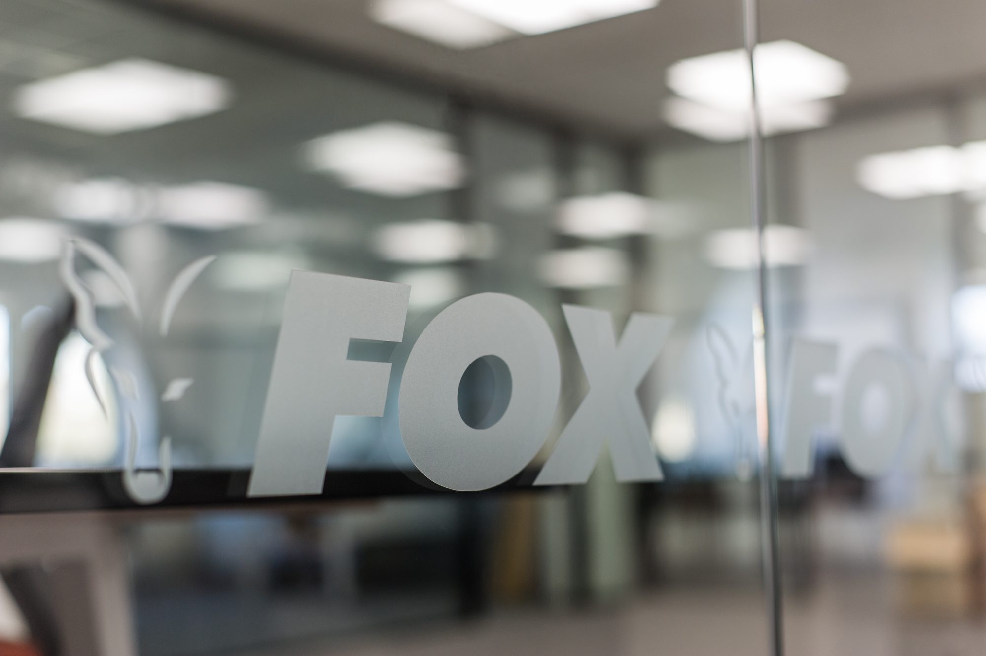 Close-up of the Fox brand mark frosted onto the glass partition