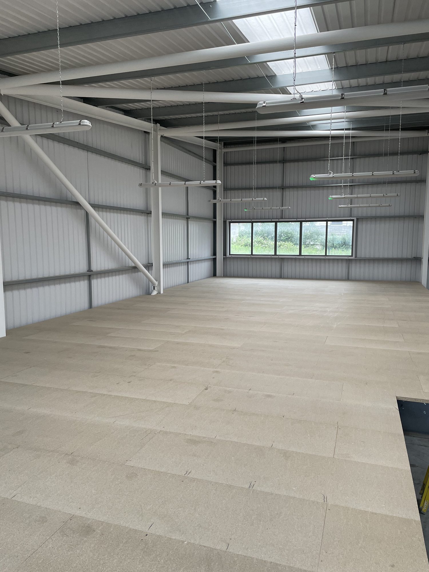 Completed mezzanine floor deck looking across the upper level toward new windows