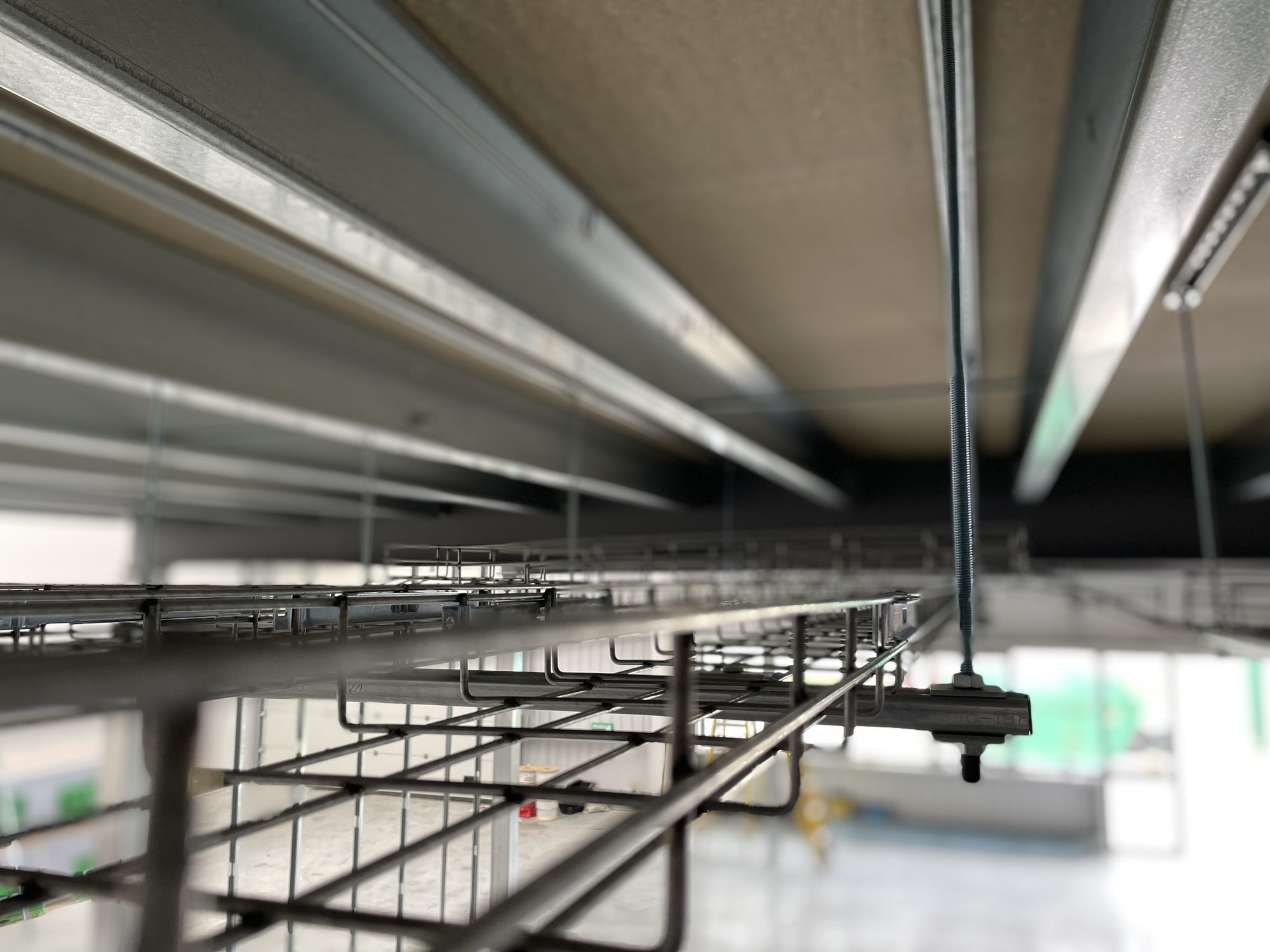 Cable basket tray running above the ceiling carrying first-fix electrics and Cat6 data cabling