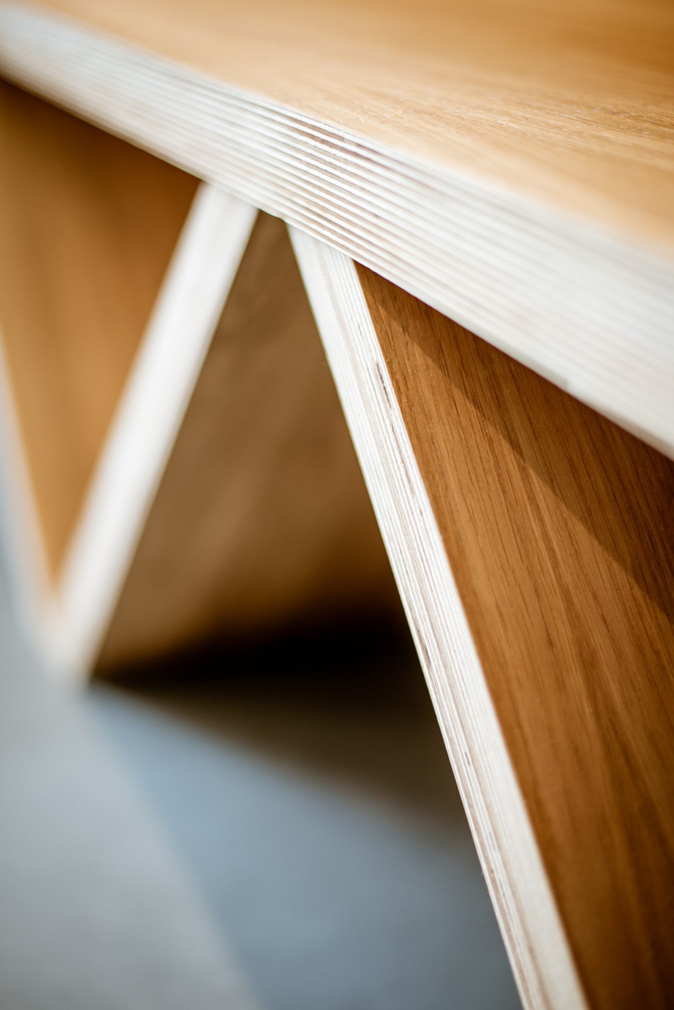 Close-up of plywood joinery edge showing the laminate stack and oak face