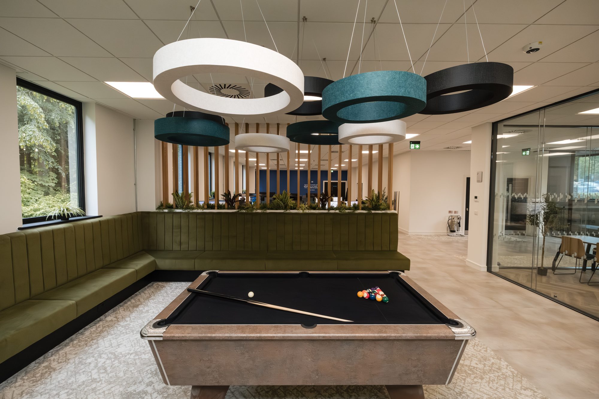 Primech Building Services HQ, Gillingham. Games room with circular acoustic baffles and pool table