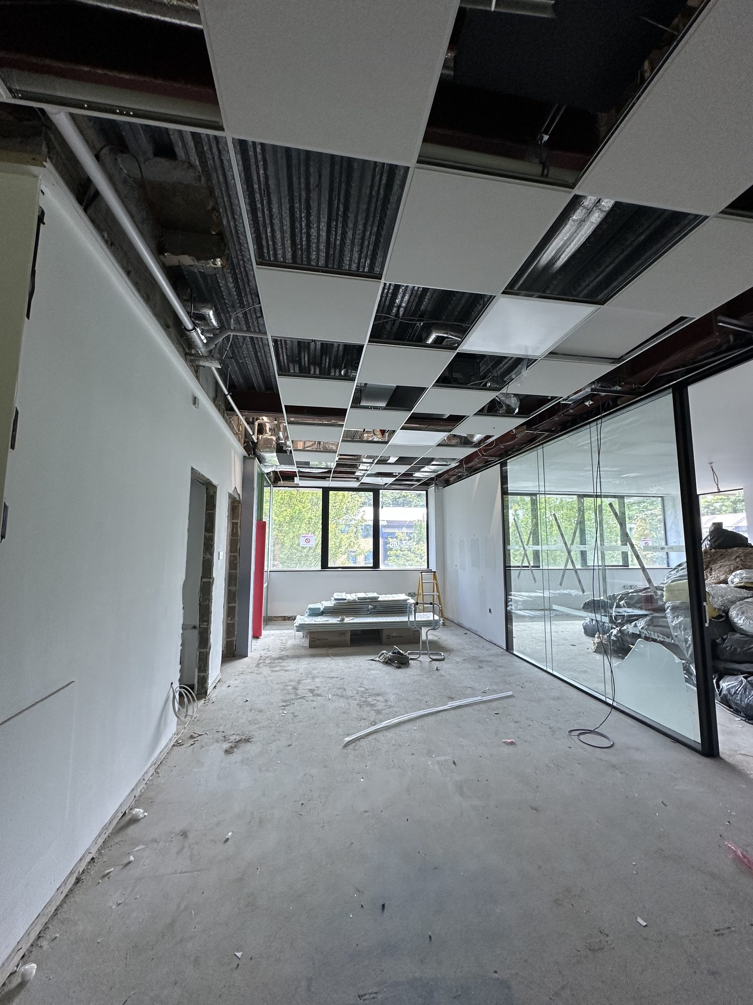 Glazed partitions installed and suspended ceiling tiles going in