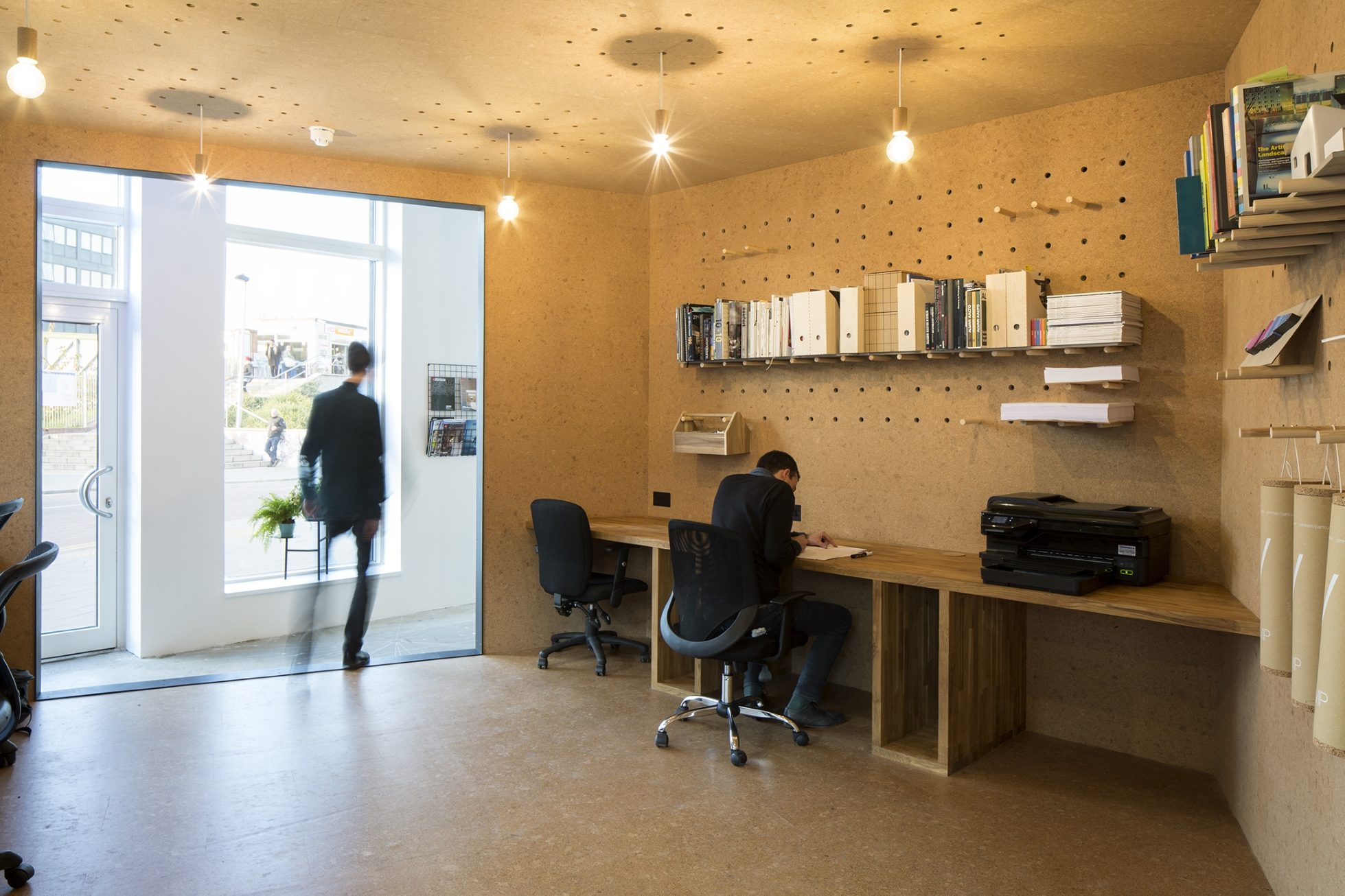 Architects working at bespoke oak desks under pendant lighting