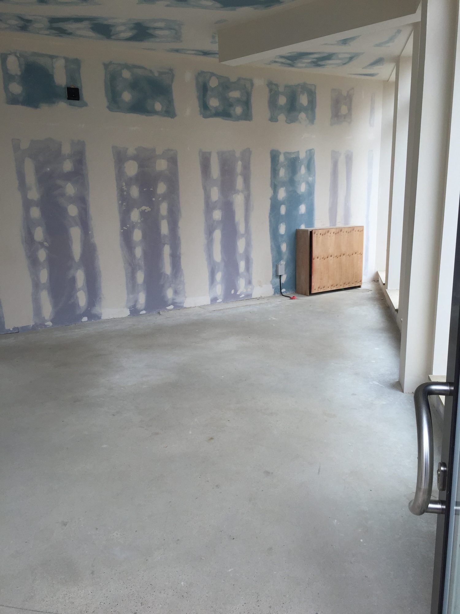 Empty unit, patched plasterboard walls and concrete floor