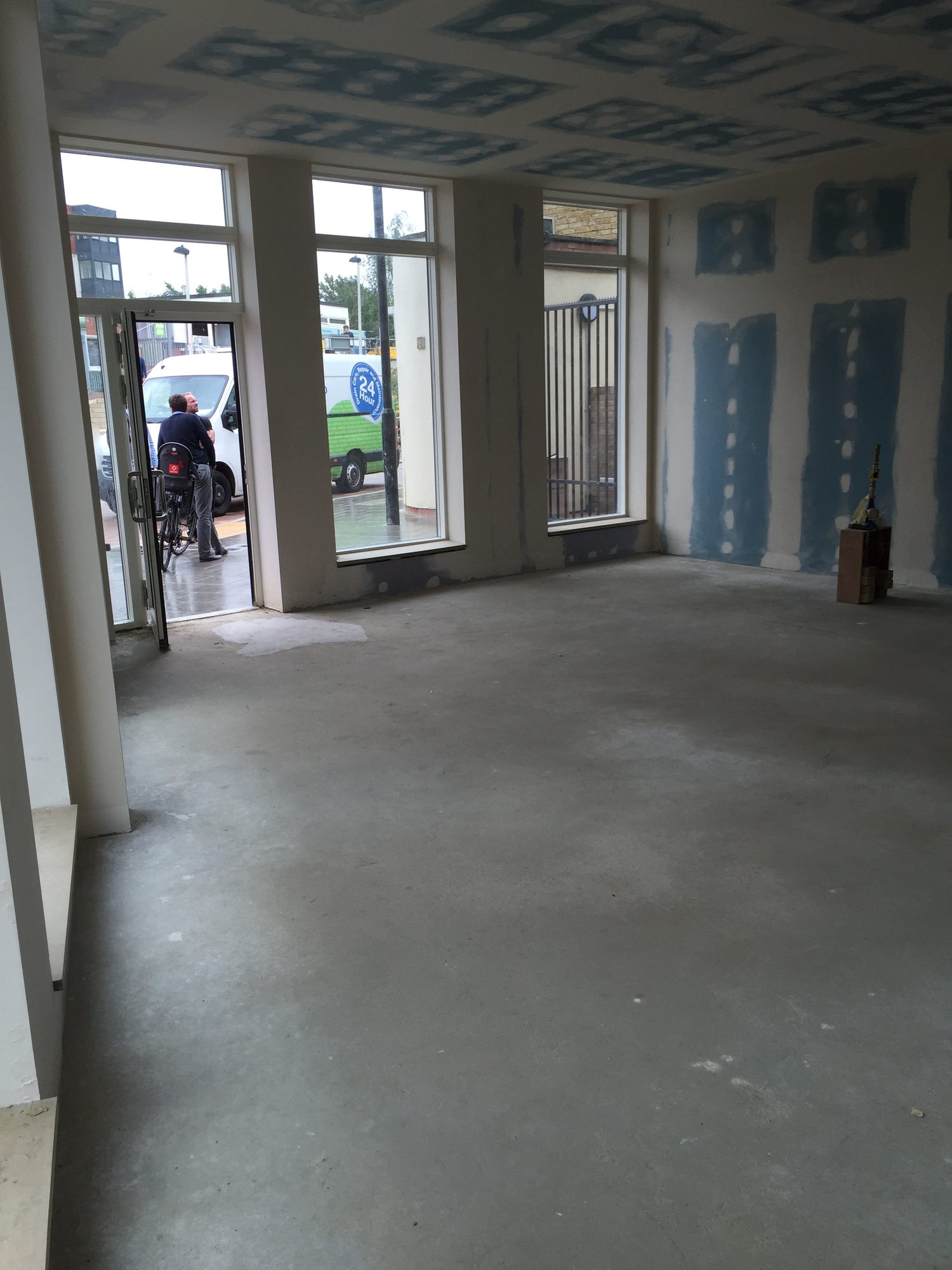 View toward street with three large windows, before fit-out